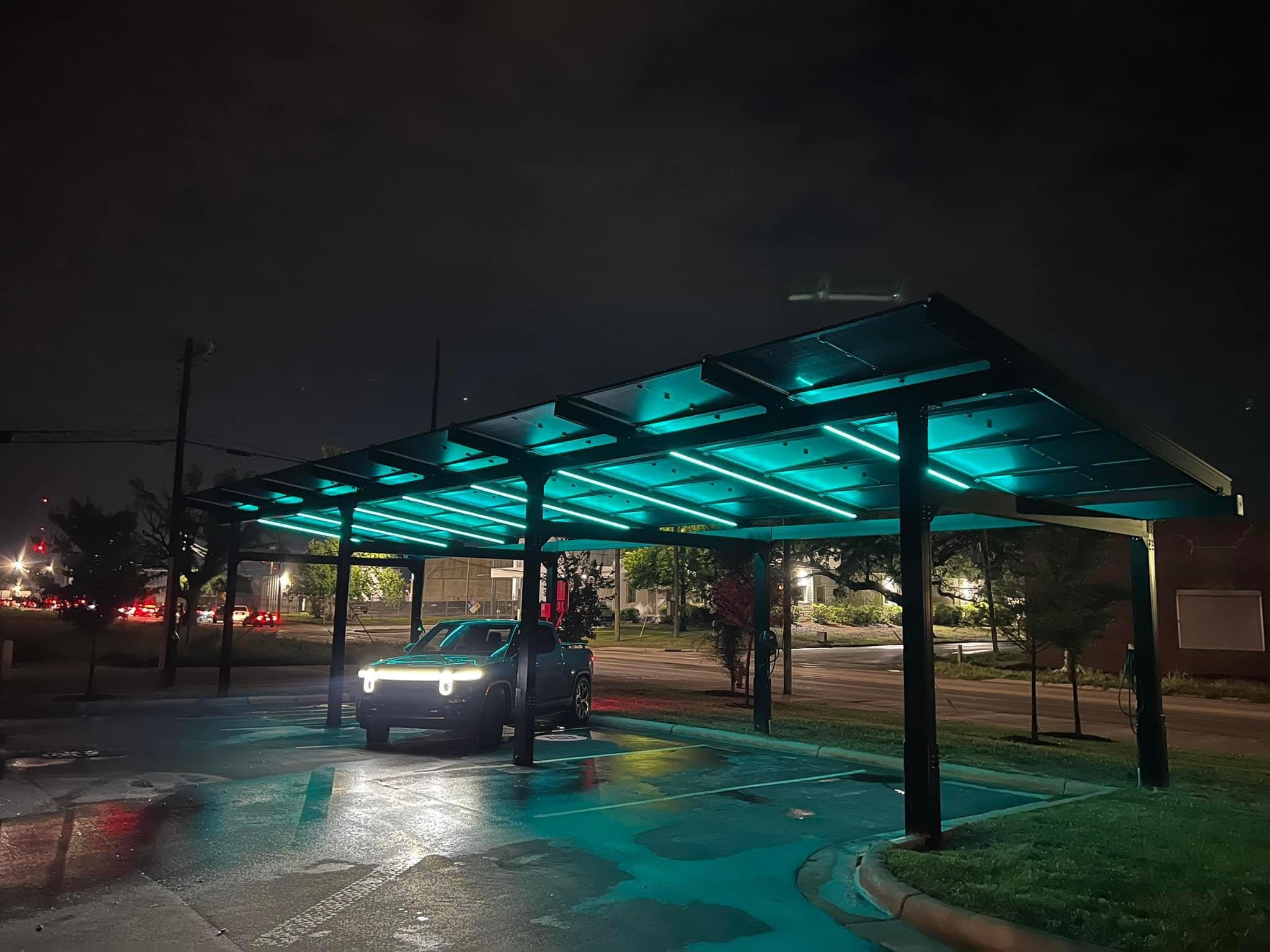 a car under a covered car shelter at night