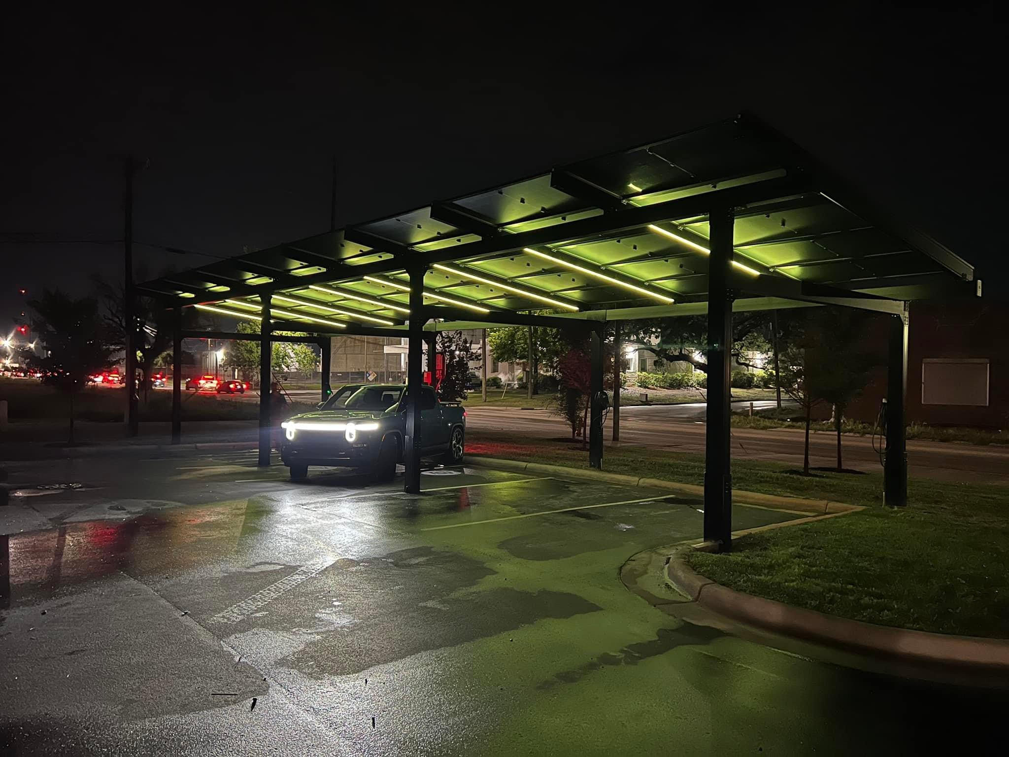 a car parked under a covered parking lot at night