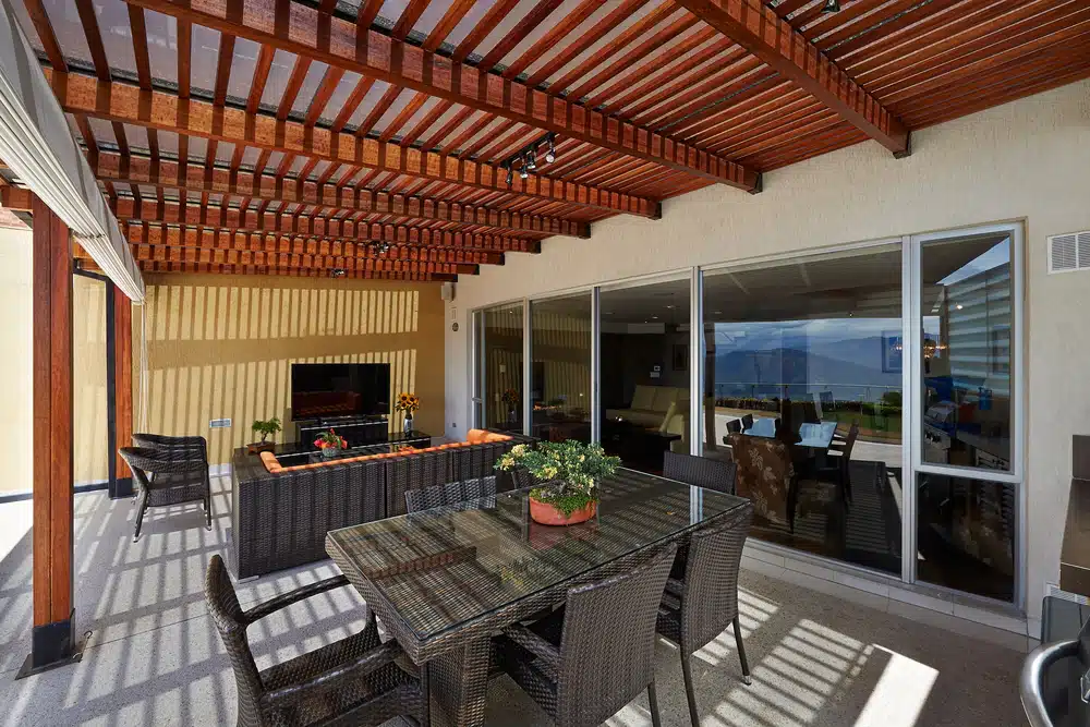 A custom cedar wood pergola at a residential house. - enVision Pergola A custom cedar wood pergola at a residential house.