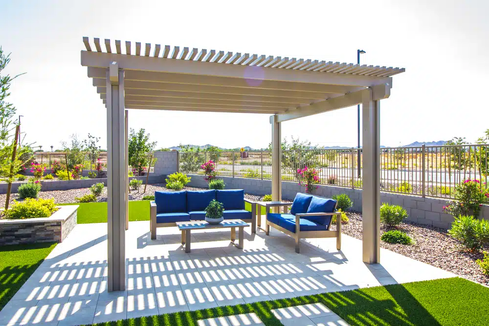 Rear Patio Pergola With Wooden Furniture - enVision Pergola A custom cedar wood standalone pergola at a residential house.