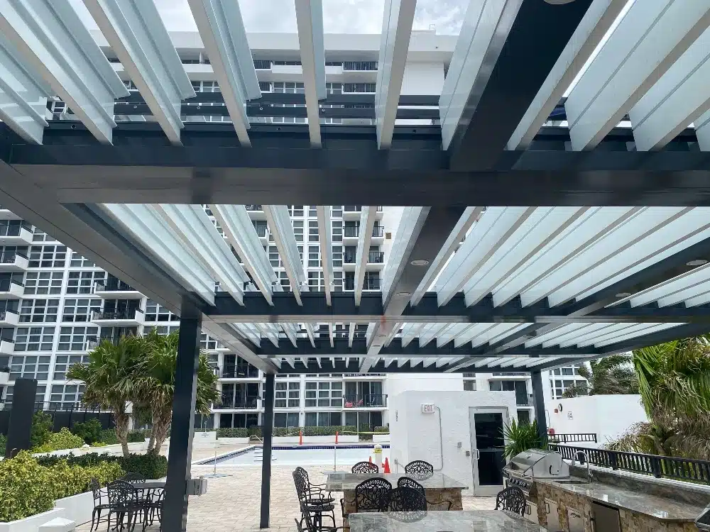 Freestanding pergola with soft lighting over a modern outdoor seating area at night
