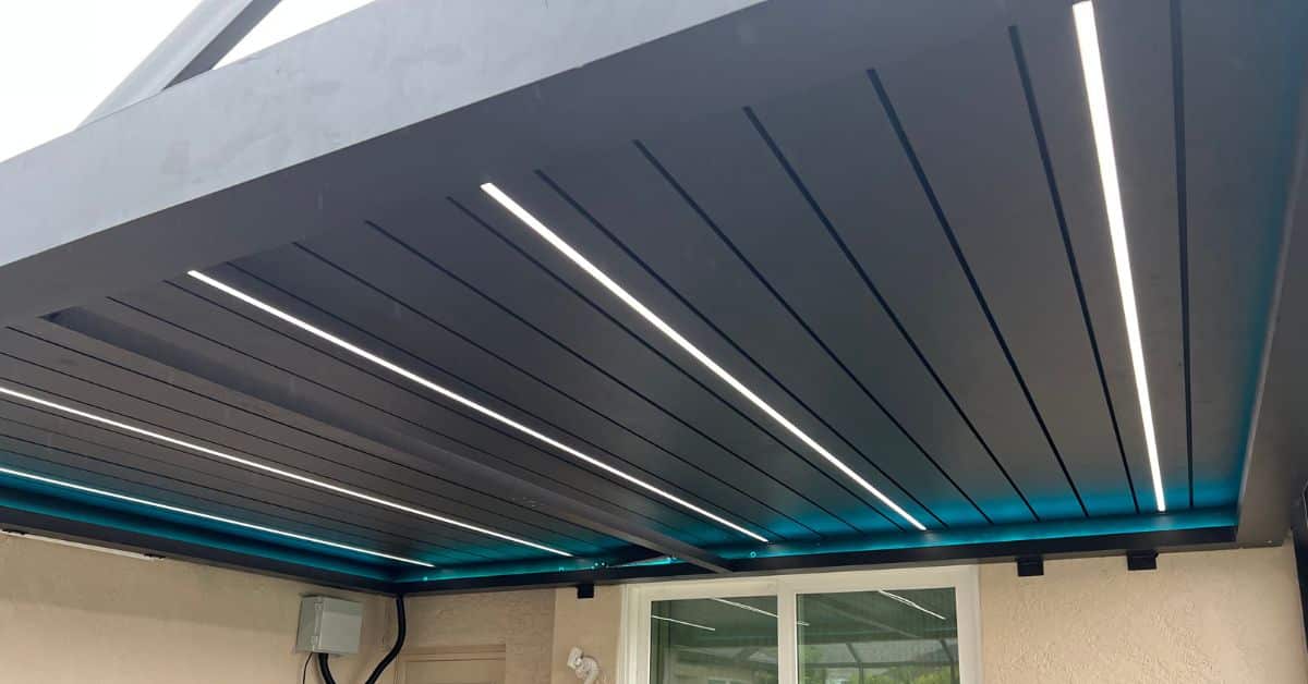 LED lighting integrated into the ceiling of a modern louvered pergola