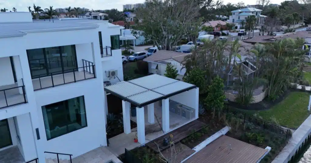 Modern Wind Resistant Pergola Installation - enVision Pergola Aerial view of an aluminum wind resistant pergola installed beside a modern home