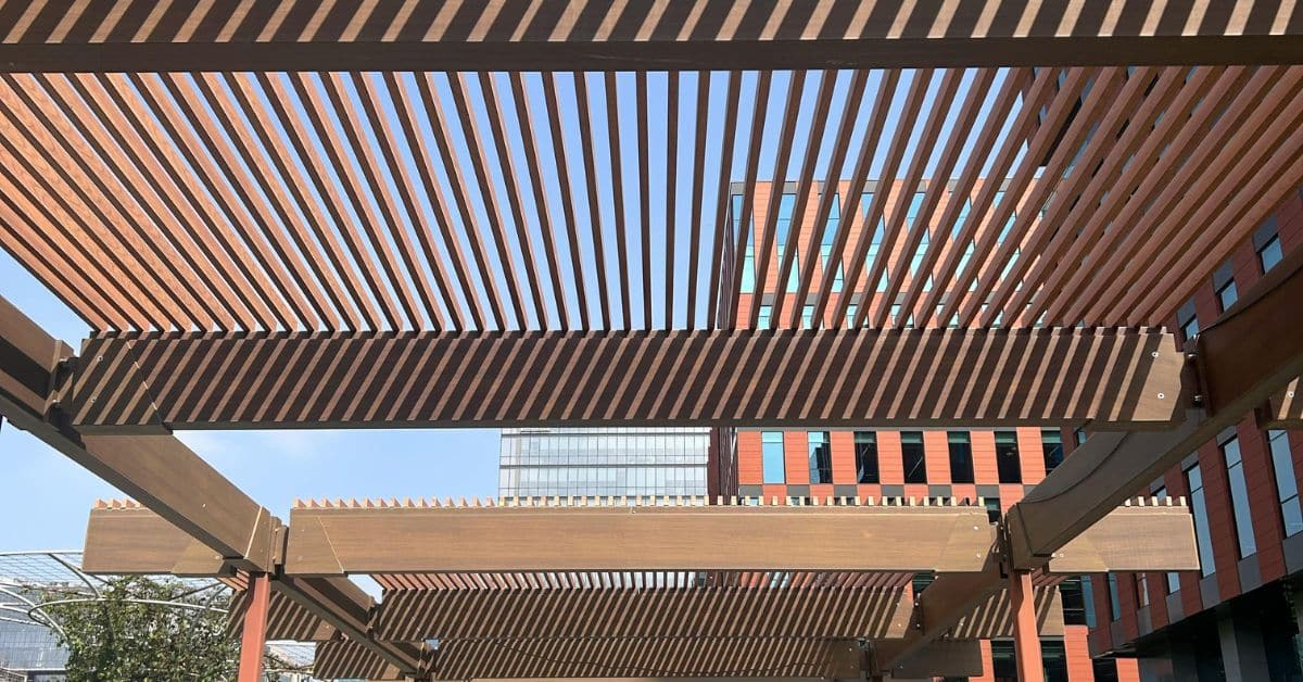 Modern wall attached pergola with slatted roof design