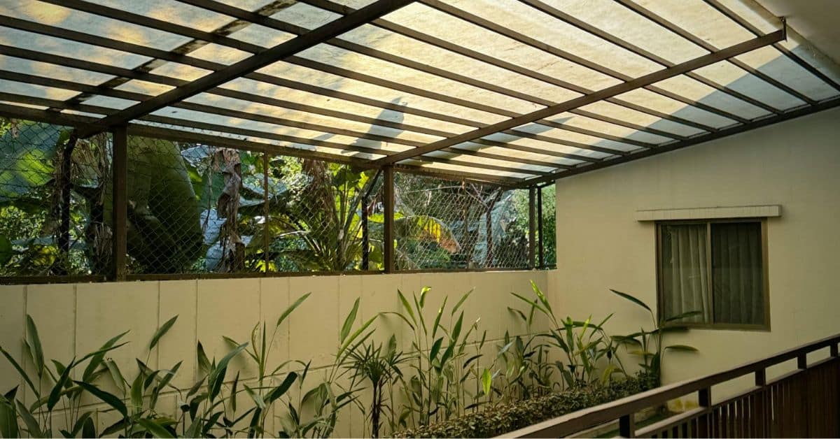 Wall mounted pergola with roof providing shaded outdoor patio space
