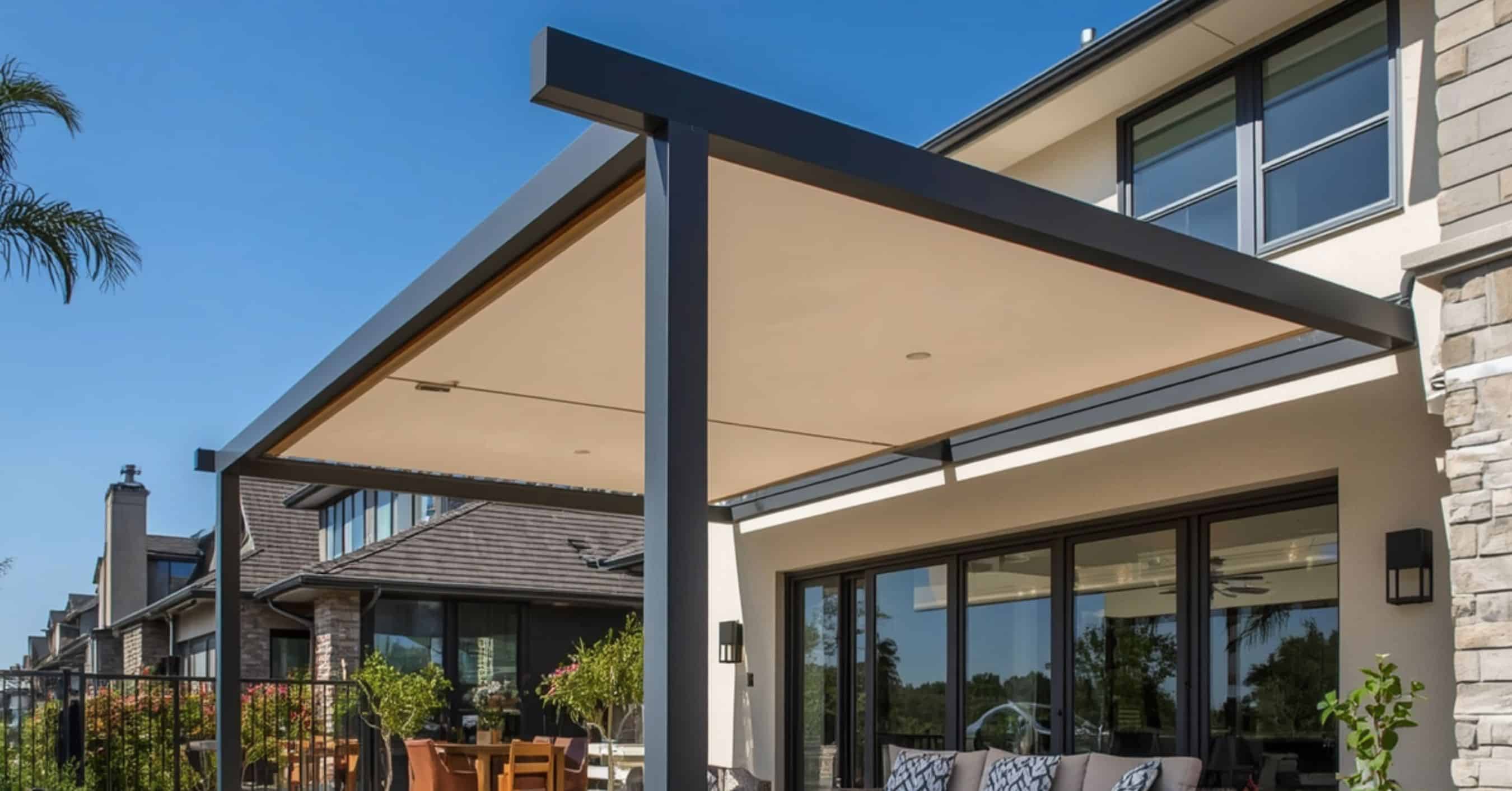 Motorized Retractable Canopy Pergola System - enVision Pergola A modern black aluminum pergola with a cream-colored motorized retractable fabric canopy extended over a luxury outdoor seating area.